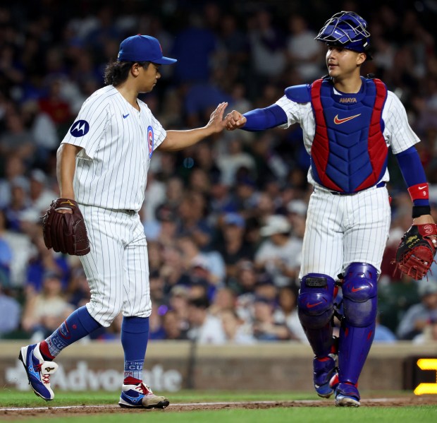 Chicago Cubs pitcher Shota Imanaga and catcher Miguel Amaya congratulate one another after shutting down the Pittsburgh Pirates in the sixth inning of a game at Wrigley Field in Chicago on Sept. 4, 2024. (Chris Sweda/Chicago Tribune)