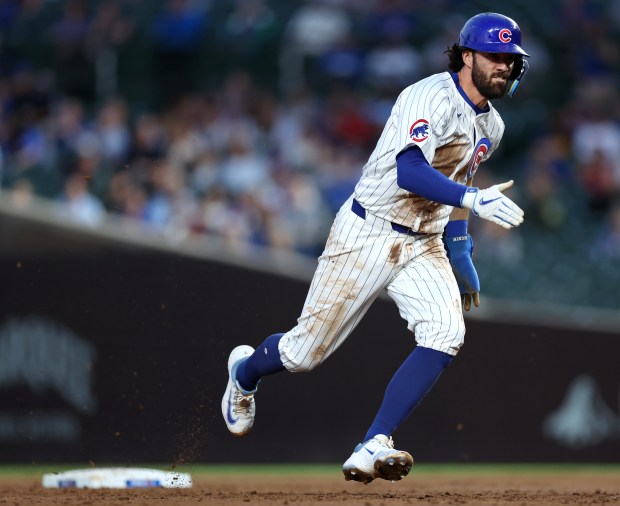 Chicago Cubs shortstop Dansby Swanson sprints toward third base while advancing on a single by teammate Christian Bethancourt in the second inning of a game against the Pittsburgh Pirates at Wrigley Field in Chicago on Sept. 3, 2024. (Chris Sweda/Chicago Tribune)