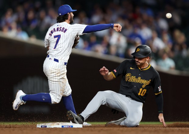 Chicago Cubs shortstop Dansby Swanson (7) throws to first base after forcing out Pittsburgh Pirates left fielder Bryan Reynolds (10) at second base in the third inning of a game at Wrigley Field in Chicago on Sept. 3, 2024. (Chris Sweda/Chicago Tribune)