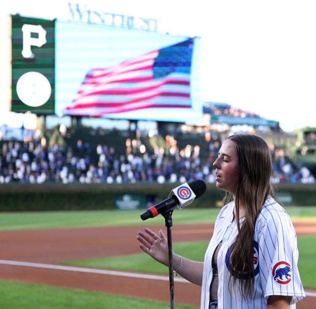 Ali Berke (cq) sings the national anthem before the start of a game between the Chicago Cubs and the Pittsburgh Pirates at Wrigley Field in Chicago on Sept. 3, 2024. (Chris Sweda/Chicago Tribune)