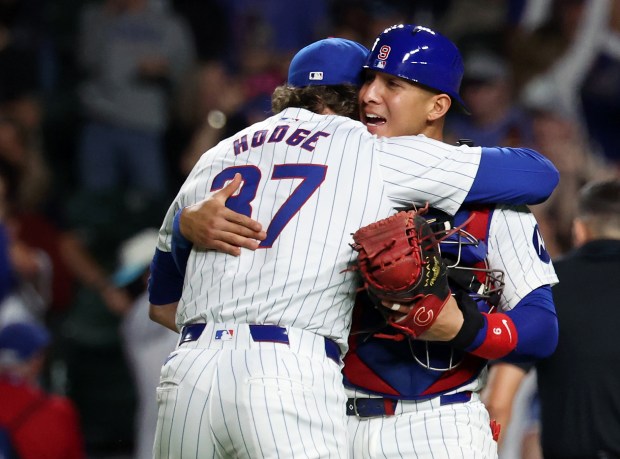 Chicago Cubs pitcher Porter Hodge (37) and catcher Miguel Amaya (9) embrace after closing out the Pittsburgh Pirates in the ninth inning of a game at Wrigley Field in Chicago on Sept. 4, 2024. Hodge, Nate Pearson, and starter Shota Imanaga combined to no-hit the Pirates. (Chris Sweda/Chicago Tribune)