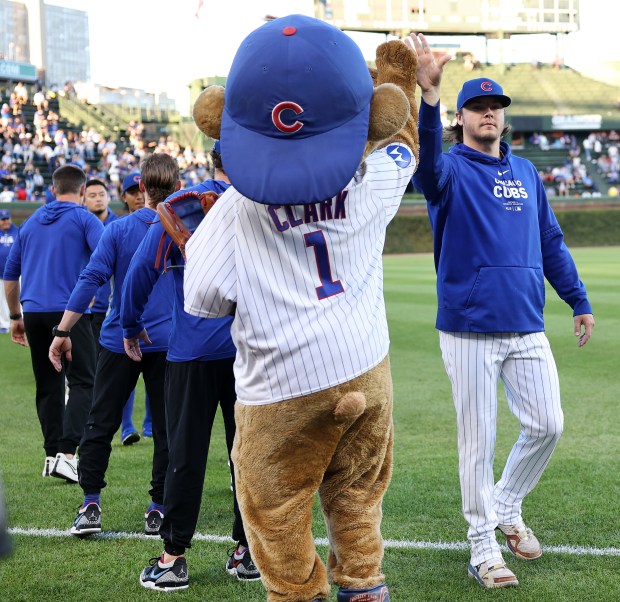 Chicago Cubs pitcher Justin Steele high fives Clark the Cub before a Cubs game against the Pittsburgh Pirates at Wrigley Field in Chicago on Sept. 3, 2024. (Chris Sweda/Chicago Tribune)