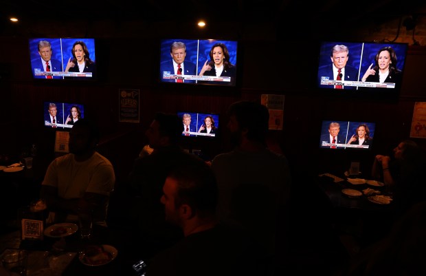 People attending a watch party hosted by Chicago Young Republicans at McGee's Tavern in Chicago's Lincoln Park neighborhood take in the presidential debate between Donald Trump and Kamala Harris on Tuesday, Sept. 10, 2024. (Chris Sweda/Chicago Tribune)