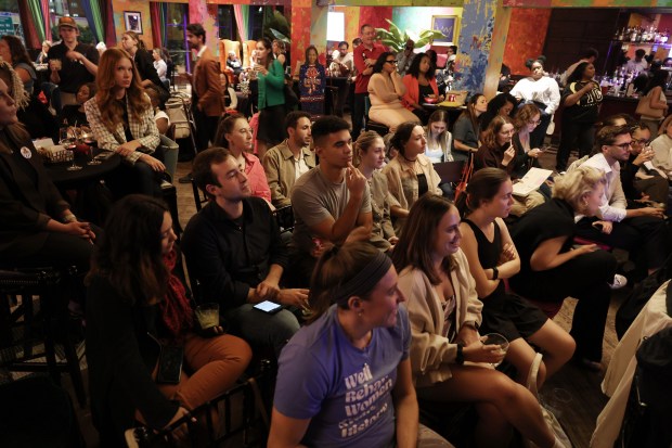 Prospective voters listen to the presidential debate during a watch party at Carnivale restaurant on Tuesday, Sept. 10, 2024, in Chicago. (John J. Kim/Chicago Tribune)