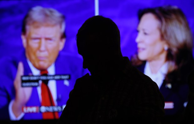 Prospective voter Pat Lannel listens to the presidential debate during a watch party at Carnivale restaurant on Tuesday, Sept. 10, 2024, in Chicago. (John J. Kim/Chicago Tribune)