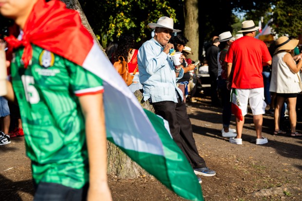 Mayolo Perez, center, drinks a piña colada at El Grito Chicago, a two-day festival in celebration of Mexican Independence Day, at Grant Park's Butler Field in Chicago on Sept. 14, 2024. (Tess Crowley/Chicago Tribune)