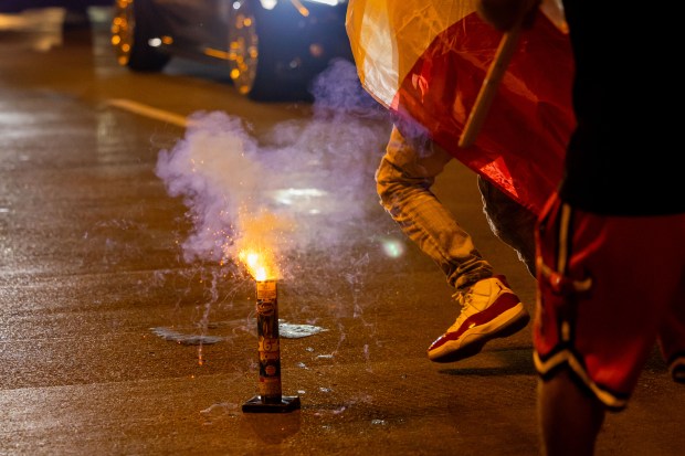 People set off fireworks on Michigan Avenue in celebration of Mexican Independence Day in Chicago on Sept. 14, 2024. (Tess Crowley/Chicago Tribune)