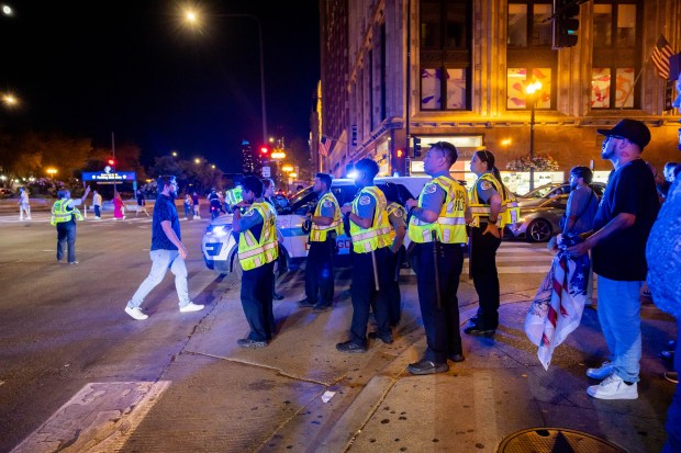 Police gather on Michigan Avenue during a celebration of Mexican Independence Day in Chicago on Sept. 14, 2024. (Tess Crowley/Chicago Tribune)