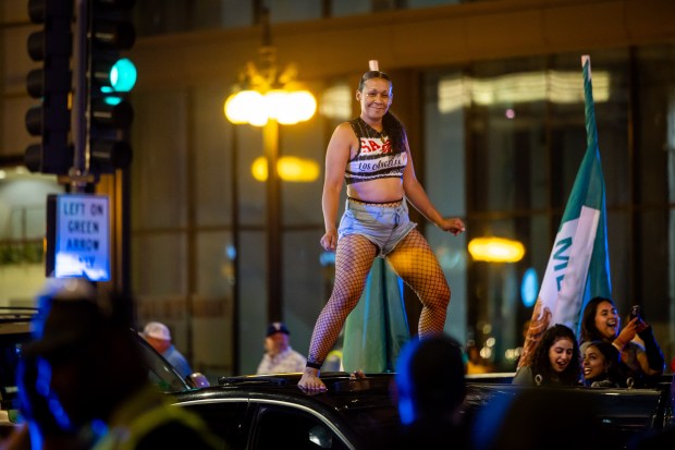 People ride down Michigan Avenue in celebration of Mexican Independence Day in Chicago on Sept. 14, 2024. (Tess Crowley/Chicago Tribune)