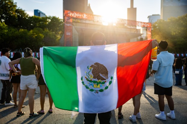 Leonardo Resendiz holds a Mexican flag at El Grito Chicago, a two-day festival in celebration of Mexican Independence Day, at Grant Park's Butler Field in Chicago on Sept. 14, 2024. (Tess Crowley/Chicago Tribune)