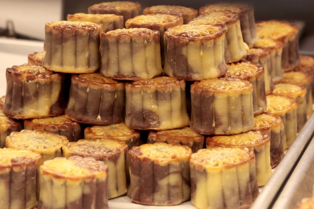 Red Bean Baby Mooncakes are stacked in a display case at Chiu Quon Bakery in Chicago's Chinatown on Sept. 5, 2024. Mooncakes are a traditional Asian pastry made during Mid-Autumn Festival. (Antonio Perez/Chicago Tribune)