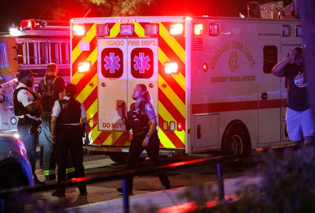 An ambulance transports a person at the scene where a 26-year-old man was fatally shot and a 25-year-old woman was shot on the 100 block of East 21st Street in the Near South Side neighborhood on Saturday, July 6, 2024, in Chicago. (Armando L. Sanchez/Chicago Tribune)