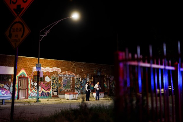 Officers work the scene where a 25-year-old man was fatally shot on the 5800 block of South Elizabeth Street in the Englewood neighborhood early Sunday July 7, 2024 in Chicago. (Armando L. Sanchez/Chicago Tribune)