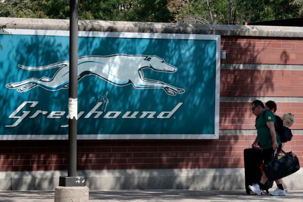 A traveler walks toward the Greyhound bus station terminal in Chicago on Aug. 27, 2024. (Antonio Perez/Chicago Tribune)