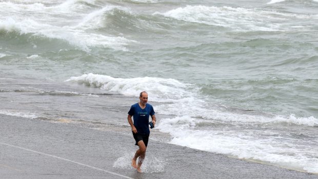 Visitors to the lakefront get a soaking from Lake Michigan, as strong winds create high waves across the bike and pedestrian path at 1100 N. Lake Shore Drive in Chicago, Sept. 27, 2024. (Antonio Perez/Chicago Tribune)