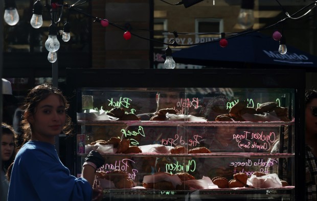 A display case of Mexican pastries is illuminated by the late afternoon sun the Lakeview Taco Fest in the 3500 block of North Southport Avenue on Saturday, Sept. 7, 2024, in Chicago. (John J. Kim/Chicago Tribune)