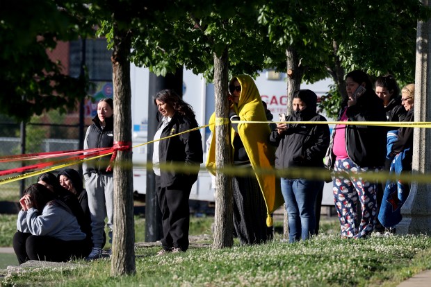 People look on at the crime cene of a fatal shooting of two people at La Villita Park in the Little Village neighborhood in Chicago on Thursday, May 30, 2024. The park includes a soccer field and is across from the Cook County jail. (Antonio Perez/Chicago Tribune)