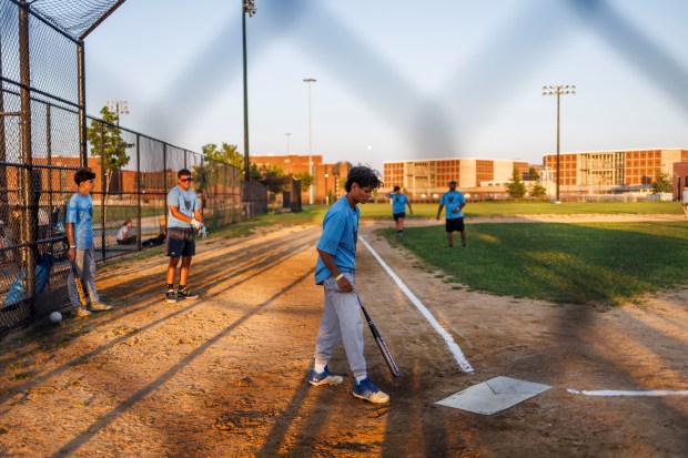 Yoel Guerra plays softball in La Villita Park on Aug. 29, 2024, in Chicago. His coaches think he has a chance of playing ball in college, so Guerra is focusing on his grades this year. (Armando L. Sanchez/Chicago Tribune)