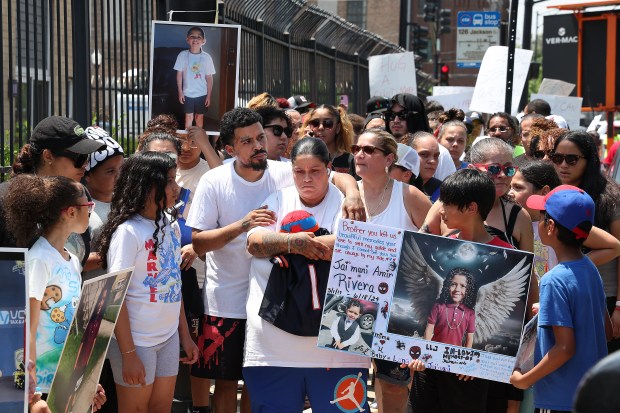 People prepare to march for peace on West Jackson Boulevard in Chicago on June 21, 2024, near the Oakley Square apartment complex where Jai'Mani Amir Rivera was shot and killed. Chicago recorded 186 homicides between June 1 and Aug. 31, data show, compared to 190 homicides in summer 2023. (Terrence Antonio James/Chicago Tribune)