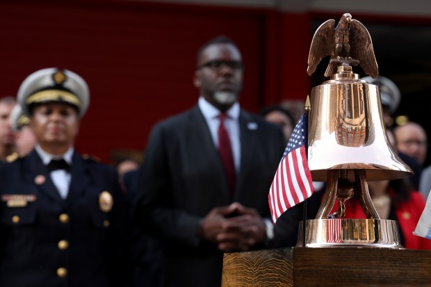 Mayor Brandon Johnsonn and Chicago firefighters mark the 23rd anniversary of the 9/11 terrorist attacks, during a memorial tribute on Sept. 11, 2024. (Antonio Perez/Chicago Tribune)