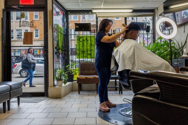 Claudia Rodriguez cuts hair at Victoria's Beauty Salon in the Chicago Lawn neighborhood on Monday Sept. 23, 2024, in Chicago. (Armando L. Sanchez/Chicago Tribune)