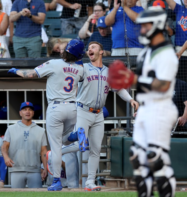 New York Mets left felder Jesse Winker (3) is congratulated by teammate Pete Alonso after Winker hit a solo home run in the first inning of a game against the Chicago White Sox at Guaranteed Rate Field in Chicago on Aug. 31, 2024. (Chris Sweda/Chicago Tribune)