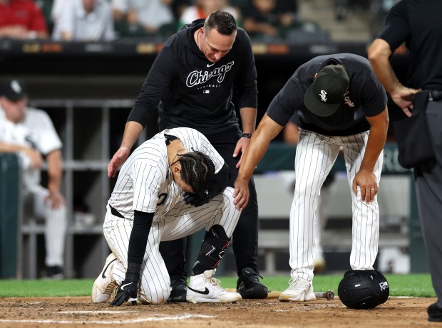 Chicago White Sox third baseman Miguel Vargas (20) is attended to after being hit by a pitch in the sixth inning of a game against the New York Mets at Guaranteed Rate Field in Chicago on Aug. 31, 2024. (Chris Sweda/Chicago Tribune)