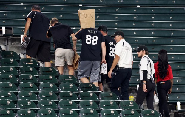 A Chicago White Sox fan with a bag on his head exits the left field bleachers after a Sox loss to the New York Mets at Guaranteed Rate Field in Chicago on Aug. 31, 2024. (Chris Sweda/Chicago Tribune)