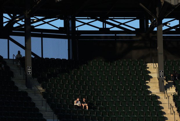 A couple fans watch the game from the left field upper deck in the second inning of a game between the Chicago White Sox and the New York Mets at Guaranteed Rate Field in Chicago on Aug. 31, 2024. (Chris Sweda/Chicago Tribune)