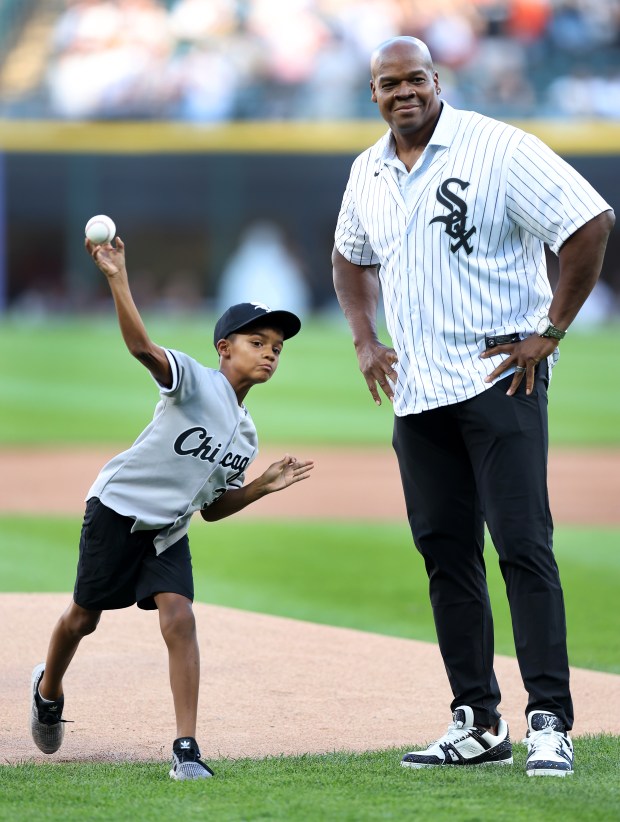 Chicago White Sox great Frank Thomas watches as his son Chase throws out a ceremonial first pitch before a game between the Sox and the New York Mets at Guaranteed Rate Field in Chicago on Aug. 31, 2024. (Chris Sweda/Chicago Tribune)