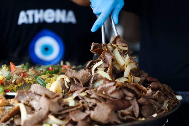 An Athena Restaurant worker serves gyro meat during Taste of Greektown in the Greektown neighborhood on Sunday, Sept. 8, 2024. (Eileen T. Meslar/Chicago Tribune)