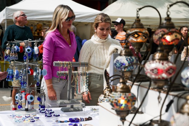 People look at items from Rich Gecko Home Fashions during Taste of Greektown in the Greektown neighborhood on Sunday, Sept. 8, 2024. (Eileen T. Meslar/Chicago Tribune)