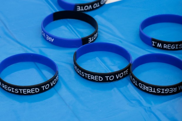 Registered to vote bracelets for students on a table during Teen Voter Registration Day at Leo High School on Tuesday, Sept. 10, 2024. (Antonio Perez/Chicago Tribune)