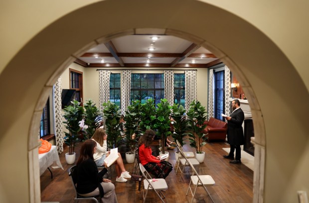 Rabbi Doved Tiechtel, right, leads prayers while observing Shabbat on Friday evening at the Illini Chabad on the campus of the University of Illinois in Champaign on Friday, Sept. 6, 2024. (Chris Sweda/Chicago Tribune)