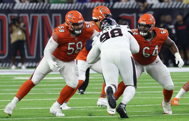 Bears offensive tackle Darnell Wright (58) and guard Nate Davis (64) work to protect quarterback Caleb Williams in the third quarter against the Texans on Sept. 15, 2024, at NRG Stadium in Houston. (John J. Kim/Chicago Tribune)