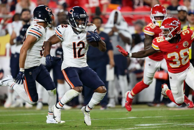 Chicago Bears wide receiver Velus Jones Jr. (12) tries to get away from Kansas City Chiefs cornerback D.J. Miller Jr. (38) during the second half of an NFL preseason football game, Thursday, Aug. 22, 2024 in Kansas City, Mo. (AP Photo/Reed Hoffmann)