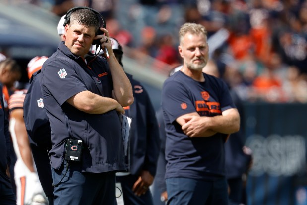 Chicago Bears offensive coordinator Shane Waldron, left, looks on from the sidelines during the second half of an NFL preseason football game against the Cincinnati Bengals, Saturday, Aug. 17, 2024, in Chicago. (AP Photo/Kamil Krzaczynski)