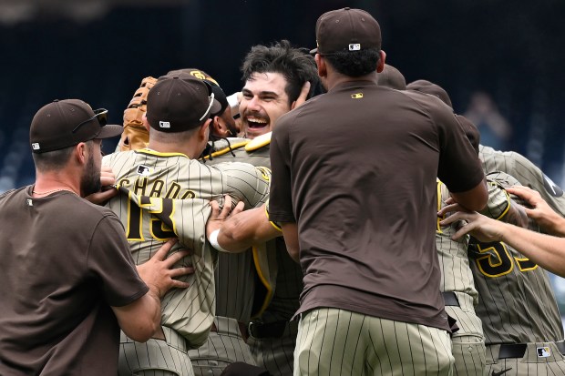 Padres players mob starting pitcher Dylan Cease, center, after his no-hitter against the Nationals on July 25, 2024, in Washington. (John McDonnell/AP)