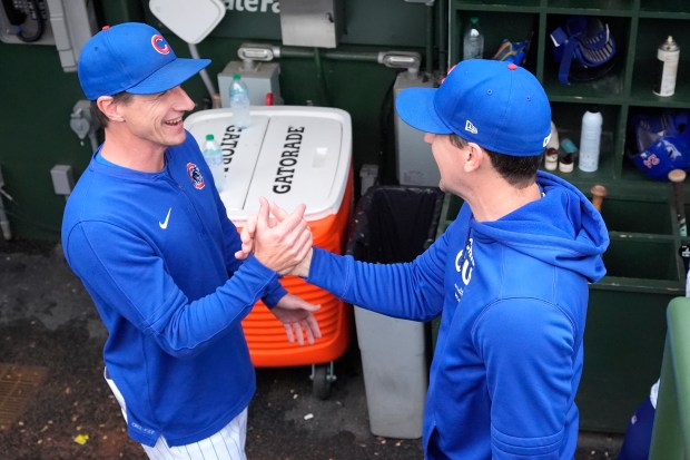 Manager Craig Counsell, left, shakes hands with starting pitcher Kyle Hendricks after the Cubs' 3-0 win against the Reds on Sept. 28, 2024, at Wrigley Field. (Charles Rex Arbogast/AP)