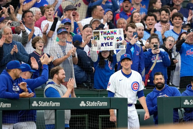 Cubs starting pitcher Kyle Hendricks steps out of the dugout for a curtain call after being pulled in the top of the eighth inning against the Reds on Sept. 28, 2024, at Wrigley Field. Hendricks allowed two hits in 7 1/3 innings in the Cubs' 3-0 win. (Charles Rex Arbogast/AP)