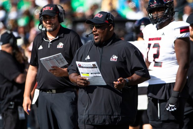 Northern Illinois coach Thomas Hammock, center, talks into his headset during a game against Notre Dame on Sept. 7, 2024, in South Bend, Ind. (Michael Caterina/AP)