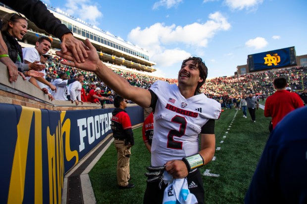 Northern Illinois quarterback Ethan Hampton celebrates with fans after the Huskies defeated Notre Dame 16-14 on Sept. 7, 2024, in South Bend, Ind. (Michael Caterina/AP)