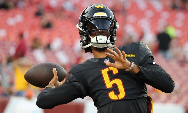 Washington Commanders quarterback Jayden Daniels (5) throws before an NFL football game against the New England Patriots, Sunday, Aug. 25, 2024 in Landover, Md. (AP Photo/Daniel Kucin Jr.)