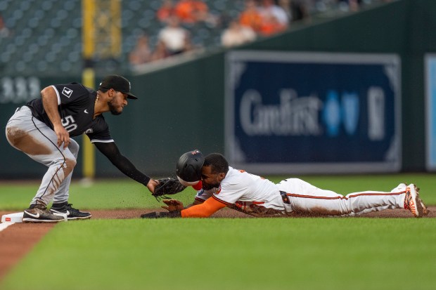 Orioles center fielder Cedric Mullins is tagged out by White Sox third baseman Lenyn Sosa in the second inning on Sept. 4, 2024, in Baltimore. (Stephanie Scarbrough/AP)