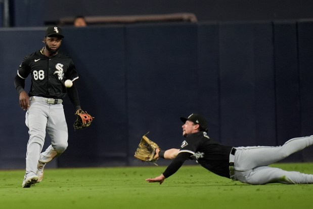 White Sox center fielder Luis Robert Jr. (88) looks on as right fielder Dominic Fletcher can't reach a two-run double by Padres center fielder Jackson Merrill during the sixth inning on Sept. 20, 2024, in San Diego. (Gregory Bull/AP)