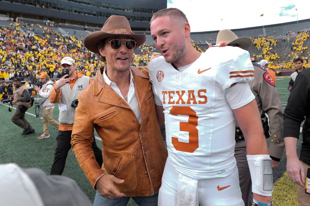 Actor Matthew McConaughey, left, celebrates with Texas quarterback Quinn Ewers after the Longhorns' 31-12 rout of Michigan on Sept. 7, 2024, in Ann Arbor, Mich. (Paul Sancya/AP)