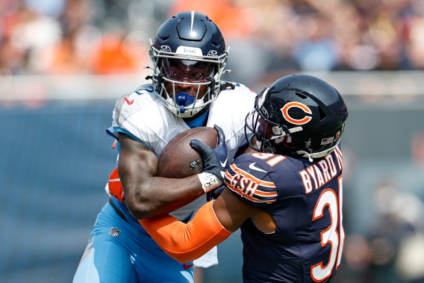 Chicago Bears safety Kevin Byard III (31) defends against Tennessee Titans running back Tyjae Spears (2) during the first half of an NFL football game, Sunday, Sept. 8, 2024, in Chicago. The Bears defeated the Titans 24-17. (AP Photo/Kamil Krzaczynski)