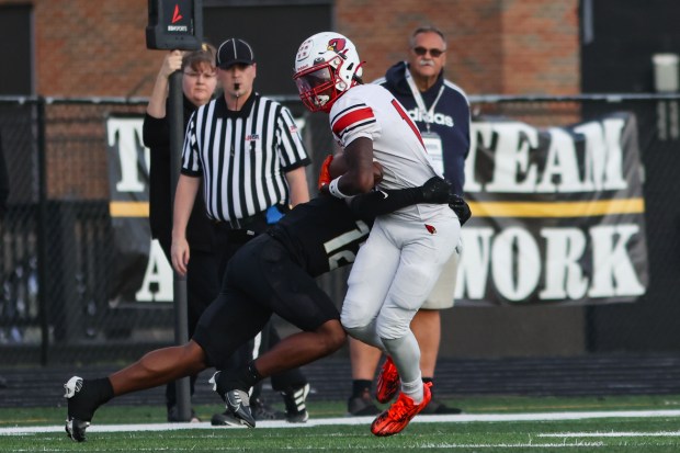 Eisenhower's Andre Lovett is tackled by Richards's Ahmad Buchannan during a game in Oak Lawn on Friday, Sept. 8, 2023. (Troy Stolt for the Daily Southtown)