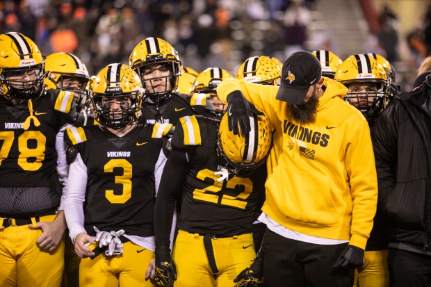 St. Laurence coach Adam Nissen comforts senior Connor Cleary (22) as the Vikings wait to receive the runner-up trophy after losing to Rochester in the Class 4A state championship game at Illinois State University's Hancock Stadium in Normal on Friday, Nov. 24, 2023.