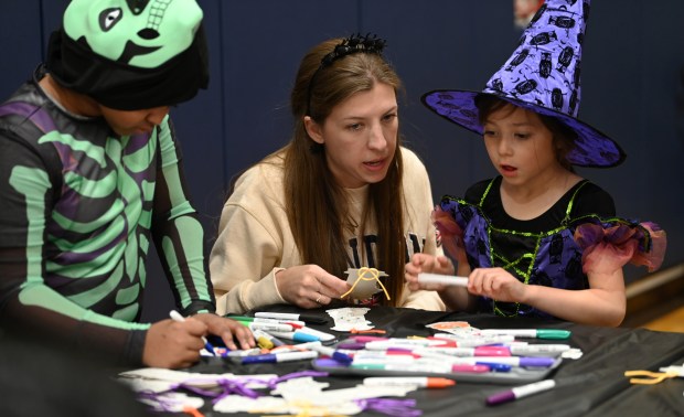 From center to left, Celina Frankland of Gurnee makes crafts with daughter Isabella Frankland at Halloween Fall Fest on Oct. 14, 2023 in Gurnee at the Hunt Club Park Community Center.